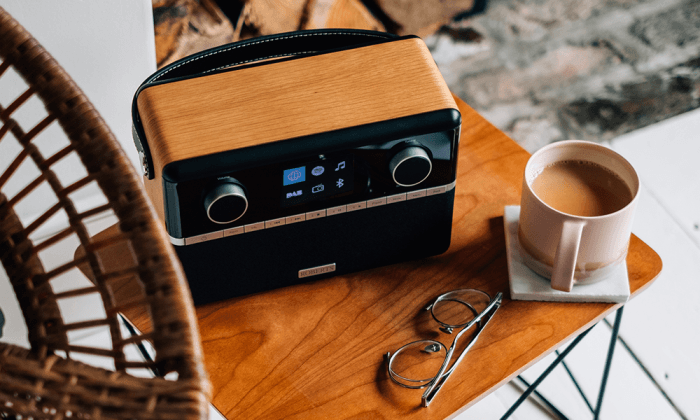 DAB-radio i tre på et bord ved siden av en kaffekopp