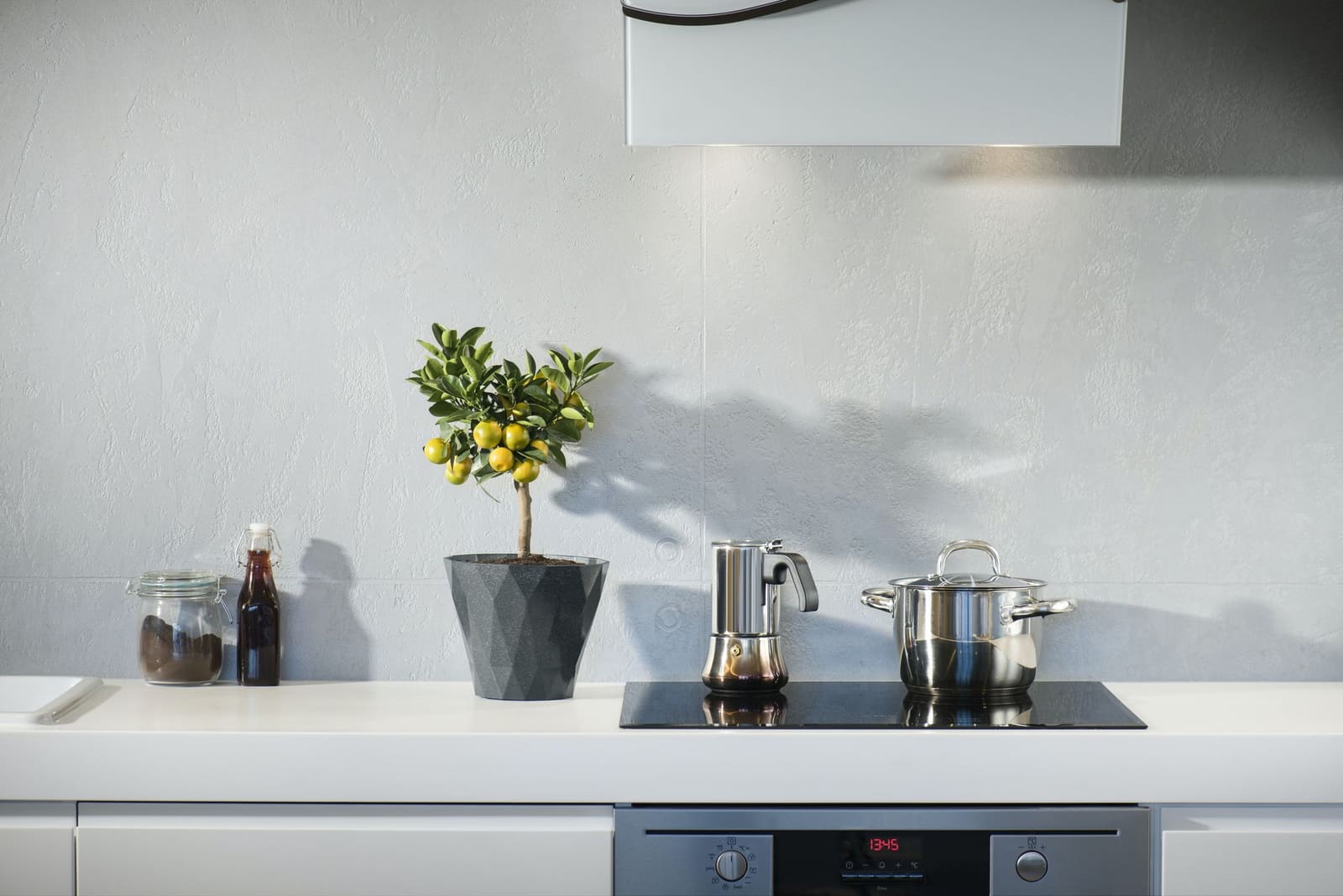 Moderne kjøkken med induksjonstopp og hvit benkeplate